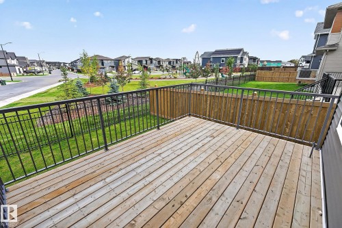 Wood deck with black metal railing and privacy fencing - 22 Sydwyck Circle, Spruce Grove, AB 