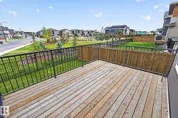 Wood deck with black metal railing and privacy fencing - 