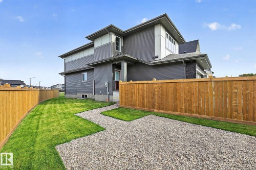 Contemporary exterior with dark gray siding, white trim, and a prominent front entrance - 22 Sydwyck Circle, Spruce Grove, AB 