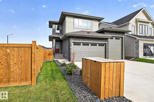 Contemporary exterior with multi-toned siding, attached garage, and a wood privacy fence - 22 Sydwyck Circle, Spruce Grove, AB 