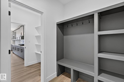Built-in mudroom bench with storage cubbies and coat hooks - 22 Sydwyck Circle, Spruce Grove, AB 
