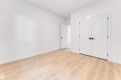 Light wood-finish flooring, white walls, and white trim - 