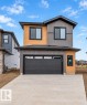 Contemporary exterior with multi-toned siding, black-framed windows, and an integrated garage - 13 Trill Point(E), Spruce Grove, AB 