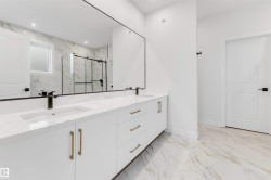 Double vanity with integrated sinks, brushed gold hardware, and a full-width mirror - 
