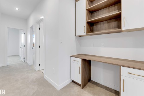 Built-in desk with wood-finish countertop, integrated cabinetry, open shelving, and recessed lighting - 13 Trill Point(E), Spruce Grove, AB 