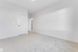 Plush carpet flooring, white painted walls, and a recessed ceiling light fixture - 