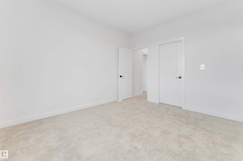 Neutral carpeting, crisp white walls, and modern interior doors with brushed nickel hardware - 13 Trill Point(E), Spruce Grove, AB 