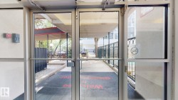 Glass double doors with aluminum framing leading to an outdoor walkway - 