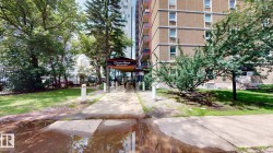 Building exterior featuring a covered walkway entrance with signage - 