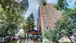 Glenora Manor high-rise building featuring a concrete facade, multiple windows, and individual balconies - 