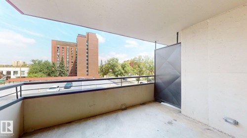 Private balcony featuring concrete flooring, a solid railing, and a partial privacy wall - #307 10140 120 Street Nw, Edmonton, AB - Outdoor With Exterior