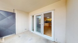 Private outdoor patio featuring a concrete surface and a decorative metal partition - 