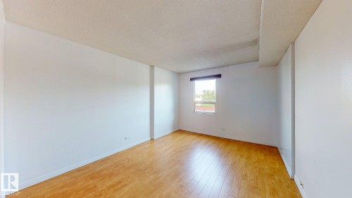 Bright interior space featuring light wood-finish flooring, white walls, and a recessed window - #307 10140 120 Street Nw, Edmonton, AB - Indoor Photo Showing Other Room