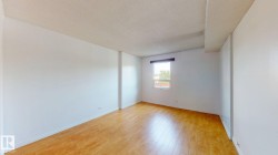 Bright interior space featuring light wood-finish flooring, white walls, and a recessed window - 