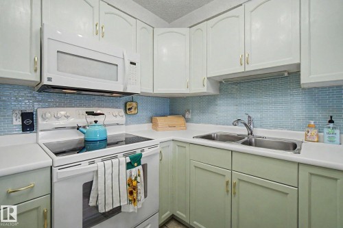 #302 224 Church Rd, Spruce Grove, AB - Indoor Photo Showing Kitchen With Double Sink