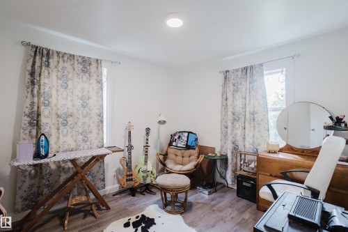 Wood-finish flooring with white walls and a ceiling-mounted light fixture - 11134 11138 116 Street Nw, Edmonton, AB 