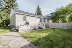 Rear exterior featuring neutral siding, a concrete patio, and fenced yard - 