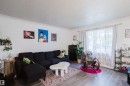 Light gray wood-finish flooring with white walls and a large window - 11134 11138 116 Street Nw, Edmonton, AB 