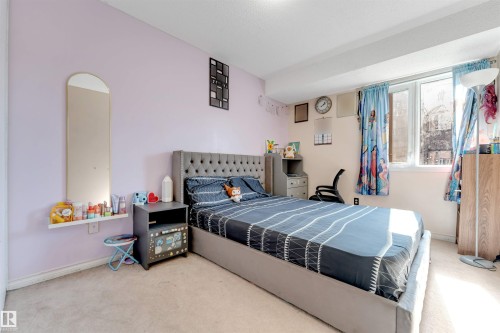Wall-to-wall carpeting and a large window providing ample illumination - #101 49 Akins Dr, St. Albert, AB 