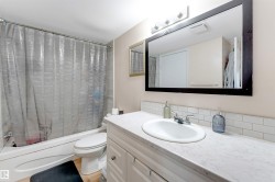 White vanity with chrome hardware, an integrated sink, and a white countertop - 