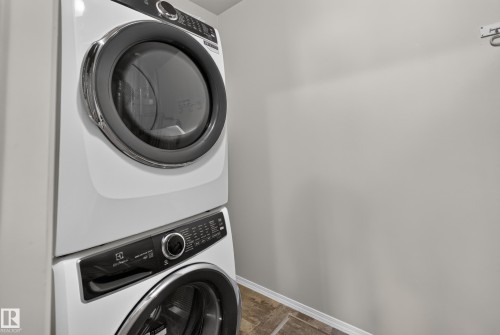 Stackable washer and dryer unit with a tiled floor - #156 460 Cranberry Wy, Sherwood Park, AB 
