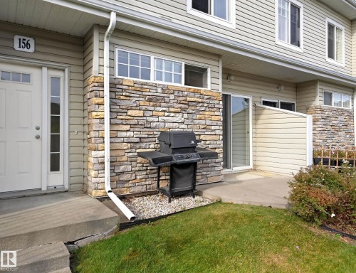Stone accent facade with vinyl siding - #156 460 Cranberry Wy, Sherwood Park, AB 