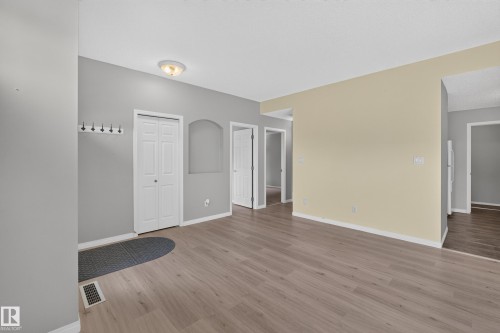 Wood-finish flooring throughout, neutral paint palette, built-in wall niche, and flush mount ceiling light fixture - #156 460 Cranberry Wy, Sherwood Park, AB 