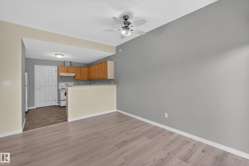 Wood-finish flooring throughout, complemented by a ceiling fan with integrated lighting - #156 460 Cranberry Wy, Sherwood Park, AB 