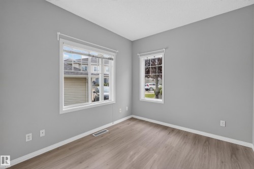 Wood-finish flooring with white trim and a neutral paint palette - #156 460 Cranberry Wy, Sherwood Park, AB 