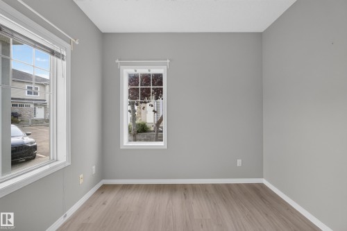 Dual windows, neutral painted walls, and wood-finish flooring - #156 460 Cranberry Wy, Sherwood Park, AB 