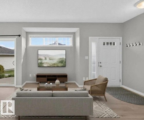 Light wood-finish flooring, sliding glass door, transom window, recessed ceiling lighting, and a paneled entry door with sidelight - #156 460 Cranberry Wy, Sherwood Park, AB 