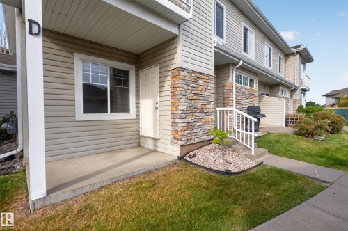 Entry with stone facade accents and a covered porch - #156 460 Cranberry Wy, Sherwood Park, AB 