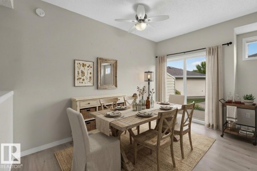 Angled ceiling with a ceiling fan, wood-finish flooring, and a sliding glass door - #156 460 Cranberry Wy, Sherwood Park, AB 