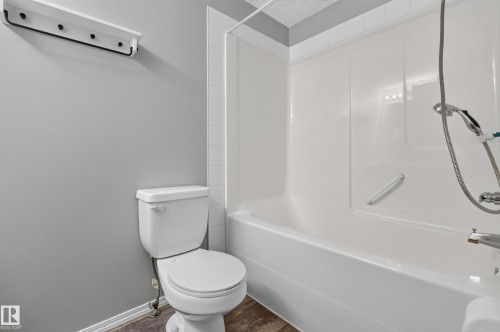 White shower-over-tub combination with integrated shelving - #156 460 Cranberry Wy, Sherwood Park, AB 