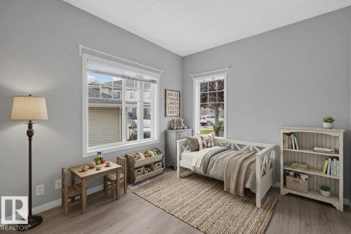 Wood-finish flooring, white trim, and two windows allowing natural light - #156 460 Cranberry Wy, Sherwood Park, AB 