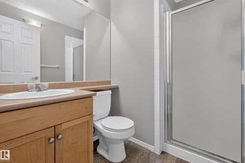 Built-in wood-finish vanity with an integrated sink and laminate countertop - #156 460 Cranberry Wy, Sherwood Park, AB 