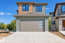 Contemporary exterior with a multi-textured facade, featuring horizontal wood-look siding and vertical paneling - 19 Tuplet Bay, Spruce Grove, AB 