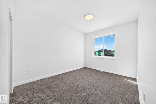 Neutral tone wall paint, gray carpeting, and a flush-mount ceiling light fixture - 19 Tuplet Bay, Spruce Grove, AB 