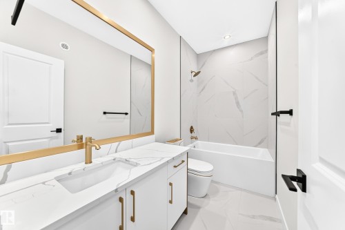 White vanity with gold-tone hardware, undermount sink, and a white countertop - 19 Tuplet Bay, Spruce Grove, AB 