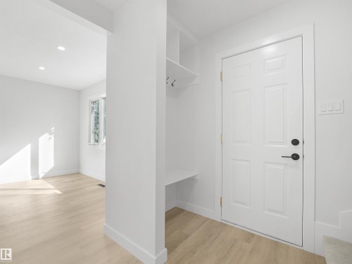 White paneled entry door with matte black hardware - 12C Twin Terrace Nw, Edmonton, AB 