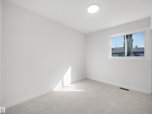 Neutral tone walls and ceiling, wall-to-wall carpeting, and a window with white trim - 12C Twin Terrace Nw, Edmonton, AB 