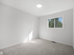 Light gray wall-to-wall carpeting with white baseboards and trim - 