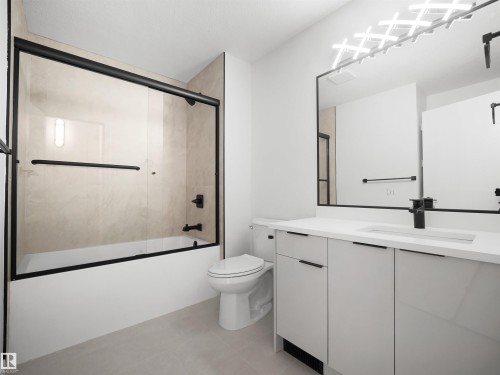 Bathroom featuring a vanity with an integrated sink, black framed mirror, and a tub with a sliding glass door - 12C Twin Terrace Nw, Edmonton, AB 