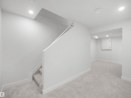 Carpeted staircase with recessed lighting, leading to a spacious carpeted area - 12C Twin Terrace Nw, Edmonton, AB 