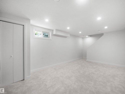 Recessed ceiling lighting, light gray wall paint, light gray carpeting, bi-fold closet doors, and a window - 12C Twin Terrace Nw, Edmonton, AB 