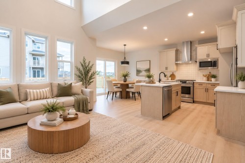 Soaring vaulted ceilings, abundant natural light, wood-finish flooring, a contemporary kitchen island, and stainless steel appliances - 4005 36 Street, Beaumont, AB 
