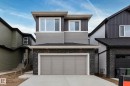 Modern exterior with varied siding, a two-car garage, stacked stone accents, and contemporary window design - 4005 36 Street, Beaumont, AB 