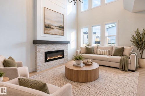 High ceilings, wood-finish flooring, stone-clad fireplace with mantel, multiple large windows, and an open concept living area - 4005 36 Street, Beaumont, AB 