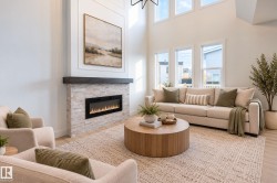 High ceilings, wood-finish flooring, stone-clad fireplace with mantel, multiple large windows, and an open concept living area - 