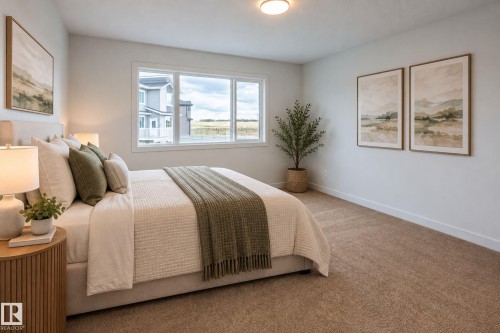 Wall-to-wall carpeting with a neutral finish, large window, and recessed lighting - 4005 36 Street, Beaumont, AB 